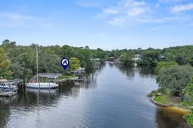 an aerial view of house with yard and mountain view in back