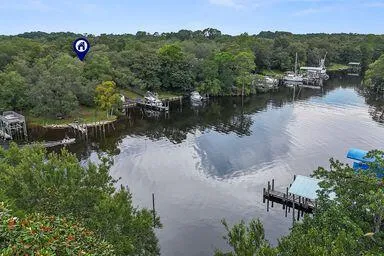 an aerial view of a house with a yard and lake view
