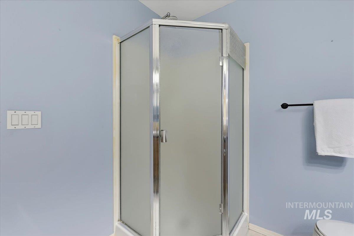 7900 Labor Camp Road Caldwell, ID 83607 - Photo 24 of 45 Built-in soaking tub with deck-mounted fixtures, surrounded by light-toned wall tile