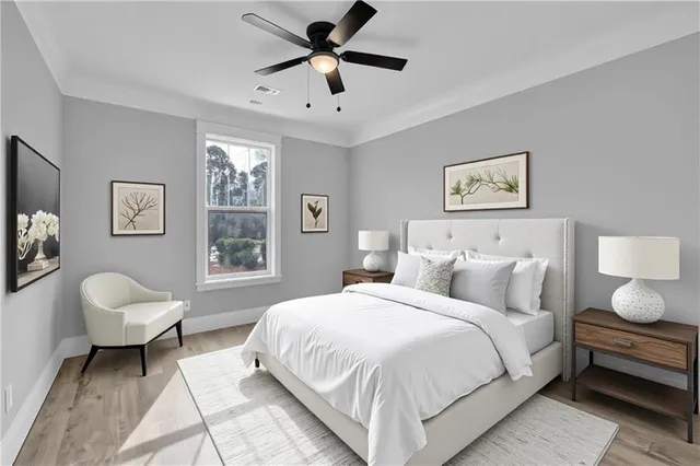 a spacious bedroom with a bed a couch and a window