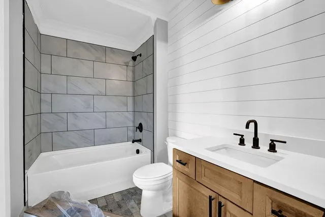 a bathroom with a sink a toilet and bathtub