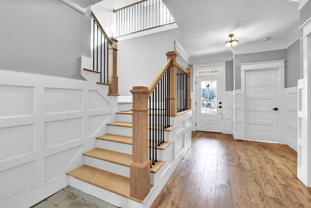 a view of entryway and hall with wooden floor