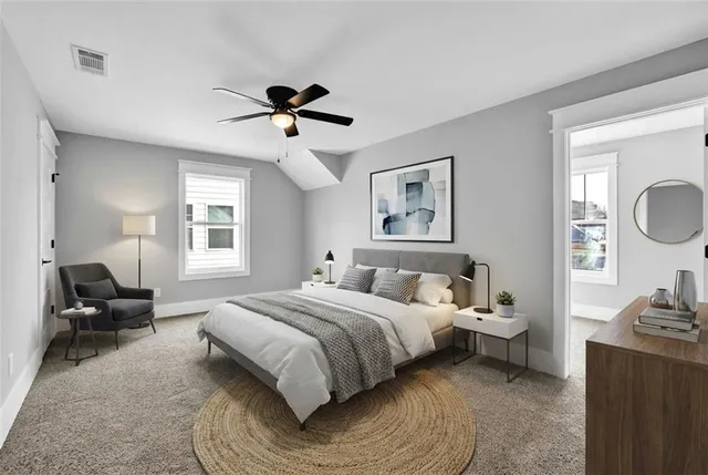 a bedroom with a bed couch and window