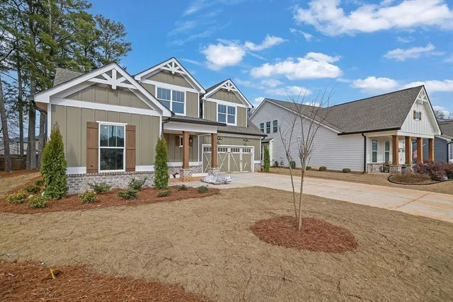 a front view of a house with a garden and yard