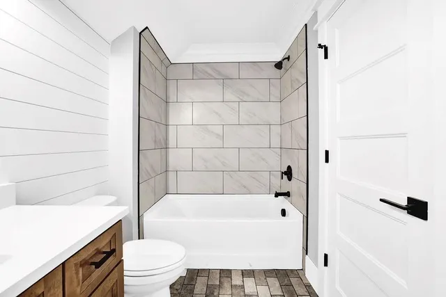 a bathroom with a bathtub and a shower