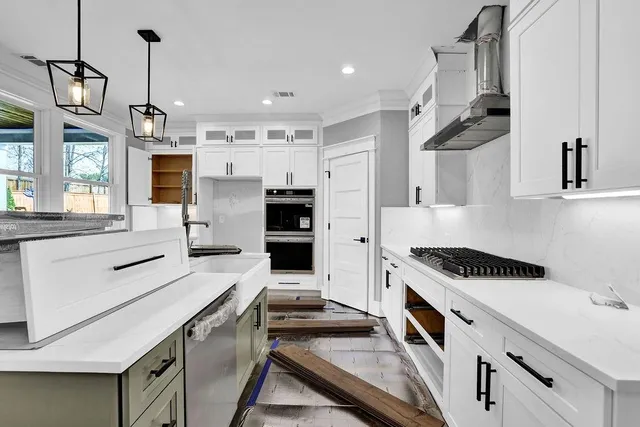 a kitchen that has a lot of cabinets in it and appliances