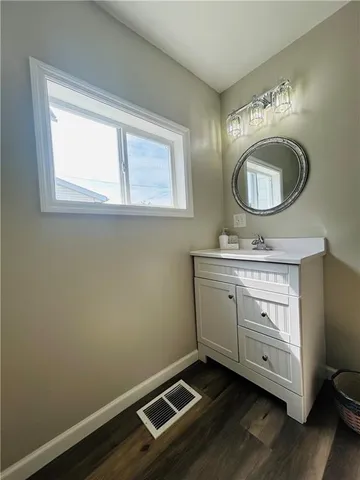 a bathroom with a sink mirror vanity and a toilet
