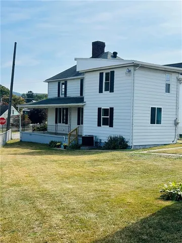 a front view of a house with a large pool