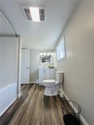 a bathroom with a toilet a sink and a mirror