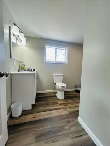 a bathroom with a sink toilet and mirror