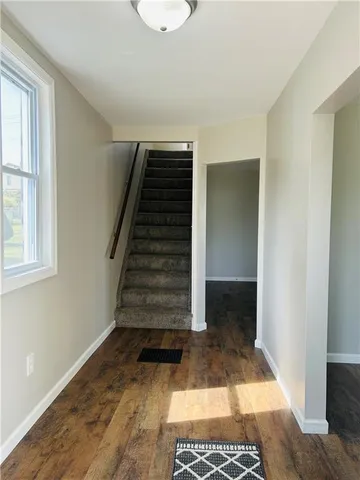 a view of entryway with wooden floor and stairs
