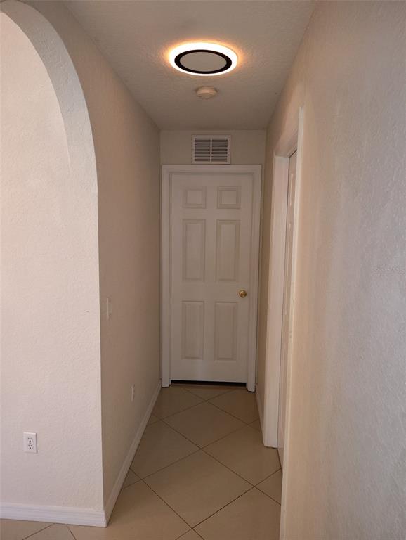 153 Rosedale Avenue Spring Hill, FL 34606 - Photo 13 of 16 an empty room with wooden floor and exposed radiator