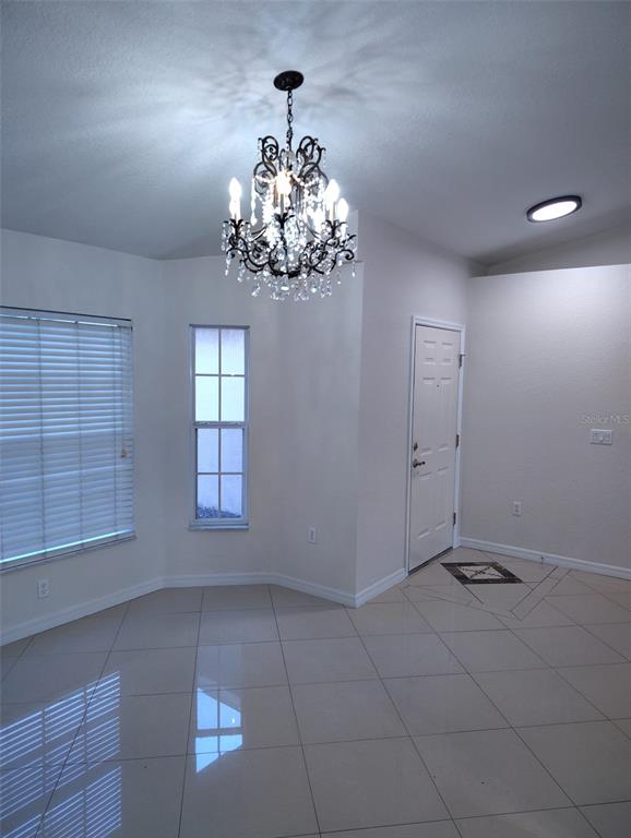 153 Rosedale Avenue Spring Hill, FL 34606 - Photo 3 of 16 a view of a chandelier in a room with a chandelier