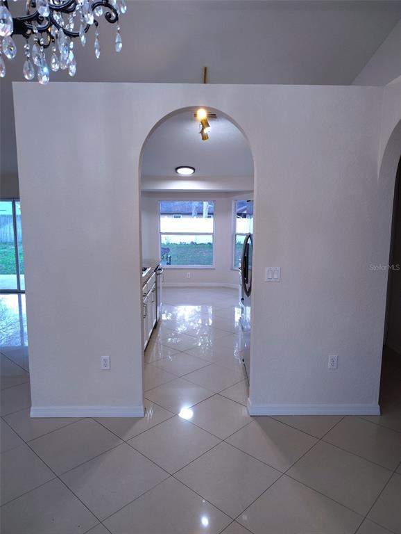 153 Rosedale Avenue Spring Hill, FL 34606 - Photo 4 of 16 an empty room with wooden floor and windows