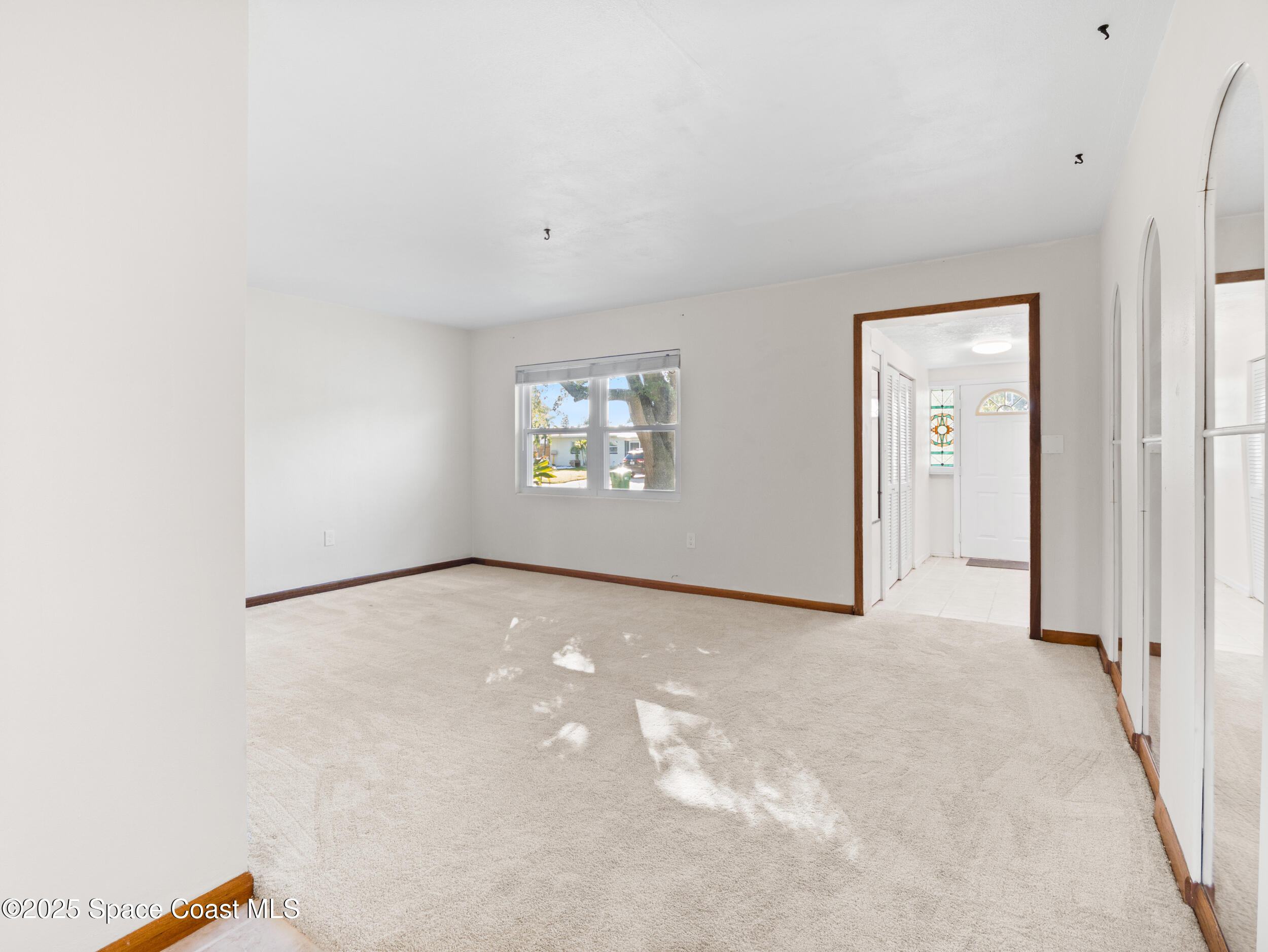 322 3rd Street Merritt Island, FL 32953 - Photo 19 of 38 a view of an empty room with a window