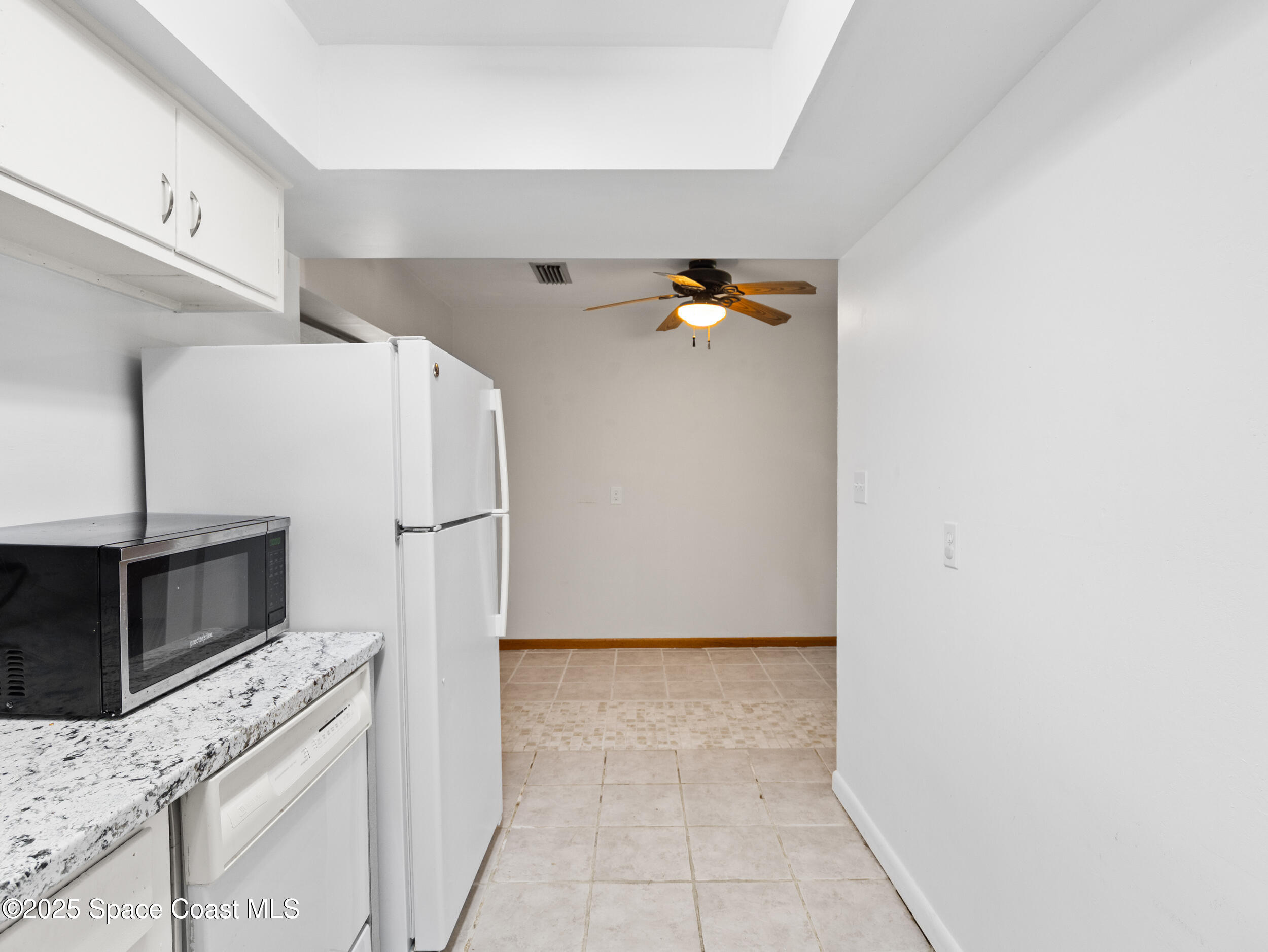 322 3rd Street Merritt Island, FL 32953 - Photo 22 of 38 a kitchen with granite countertop a refrigerator and a stove