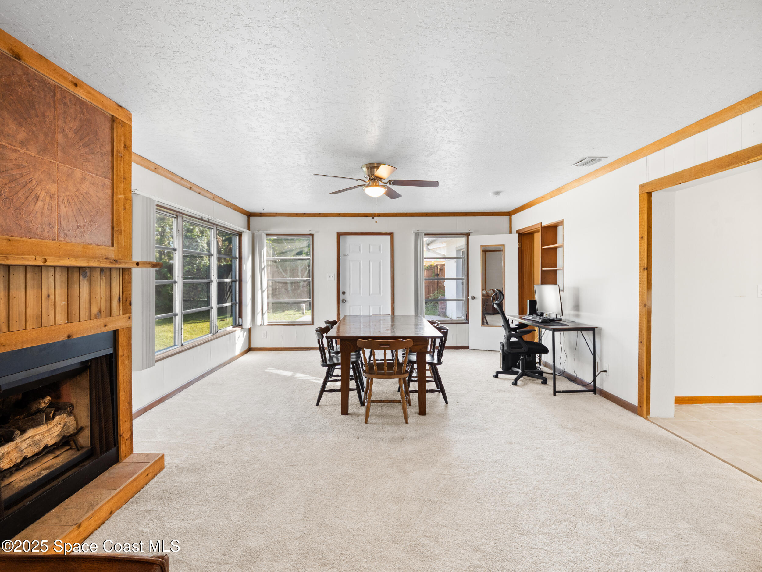 322 3rd Street Merritt Island, FL 32953 - Photo 23 of 38 a living room with furniture and a fireplace