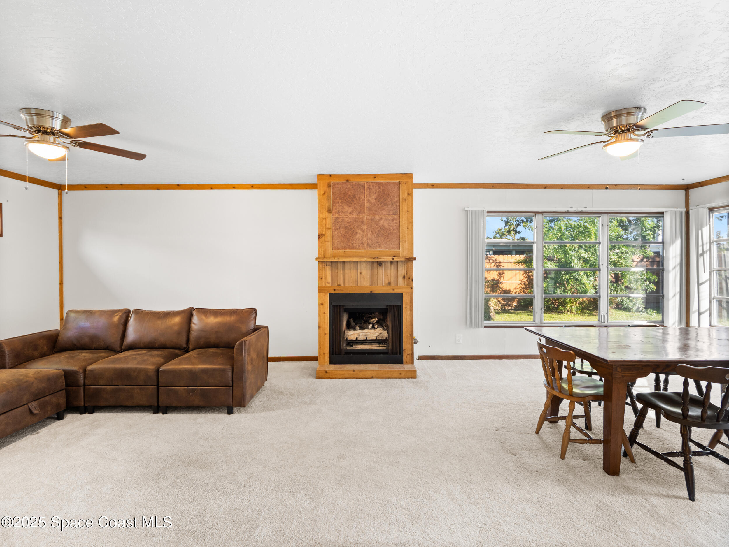 322 3rd Street Merritt Island, FL 32953 - Photo 25 of 38 a living room with furniture and a fireplace