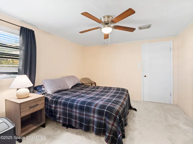 a bedroom with bed and window