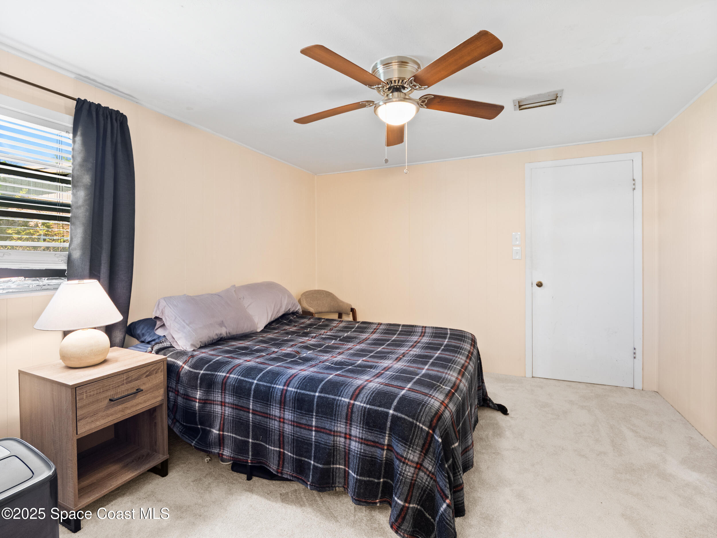 322 3rd Street Merritt Island, FL 32953 - Photo 27 of 38 a bedroom with bed and window