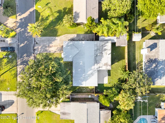 a aerial view of a house with a yard and garden