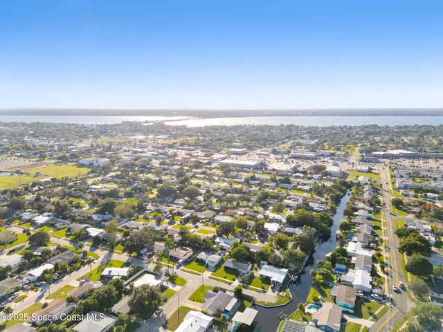 an aerial view of residential building and trees around