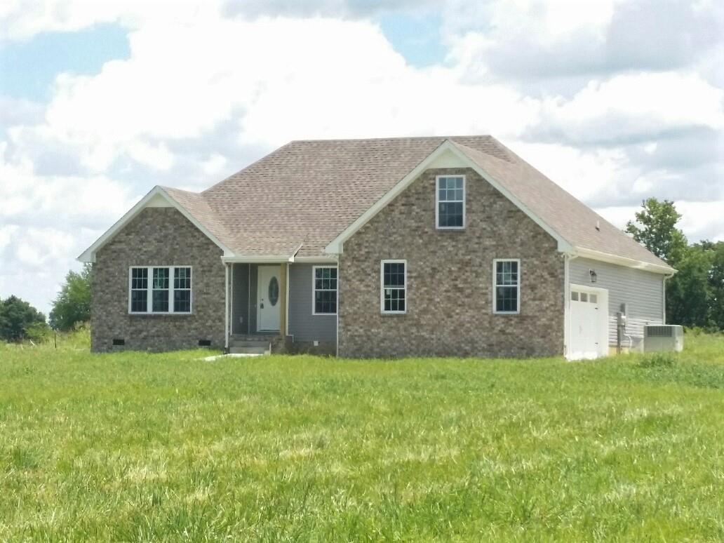 558 Corinth Road Portland, TN 37148 - Photo 1 of 10 a front view of house with yard and trees in the background