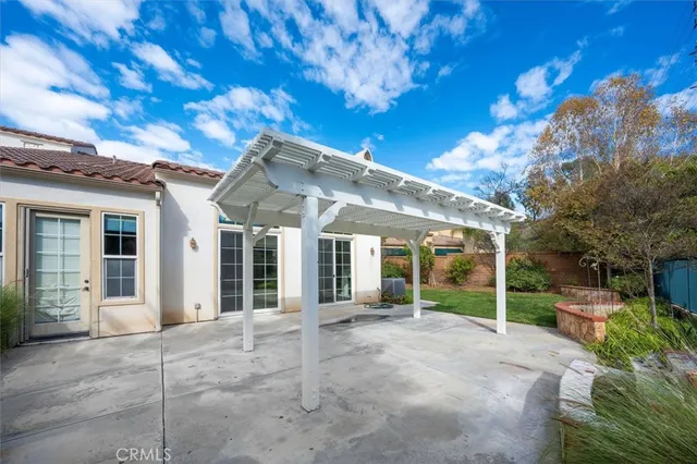 a view of a garden with plants and large trees