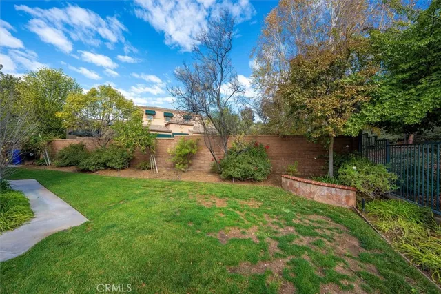 a view of a house with backyard and porch