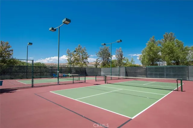 a view of a livingroom with furniture and floor to ceiling window