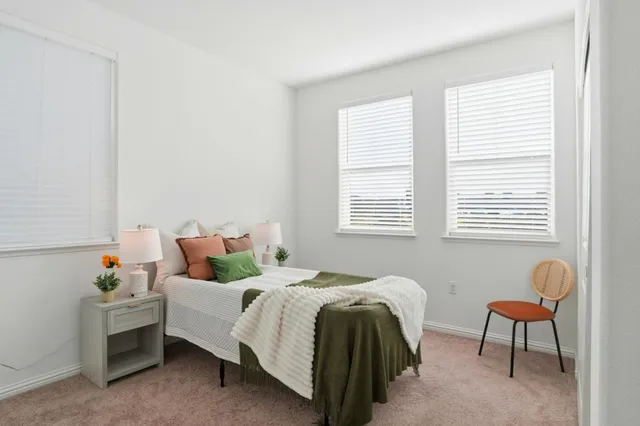 a bedroom with a bed and a window