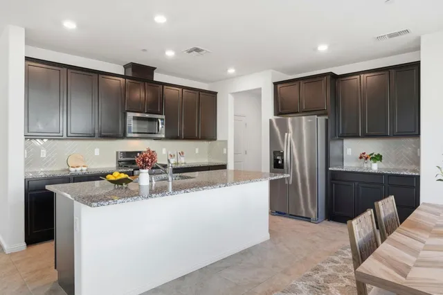 a kitchen with refrigerator cabinets and furniture