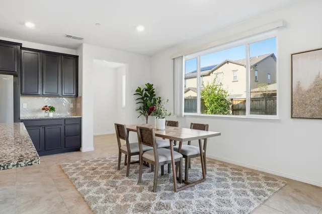 a dining room with furniture and window