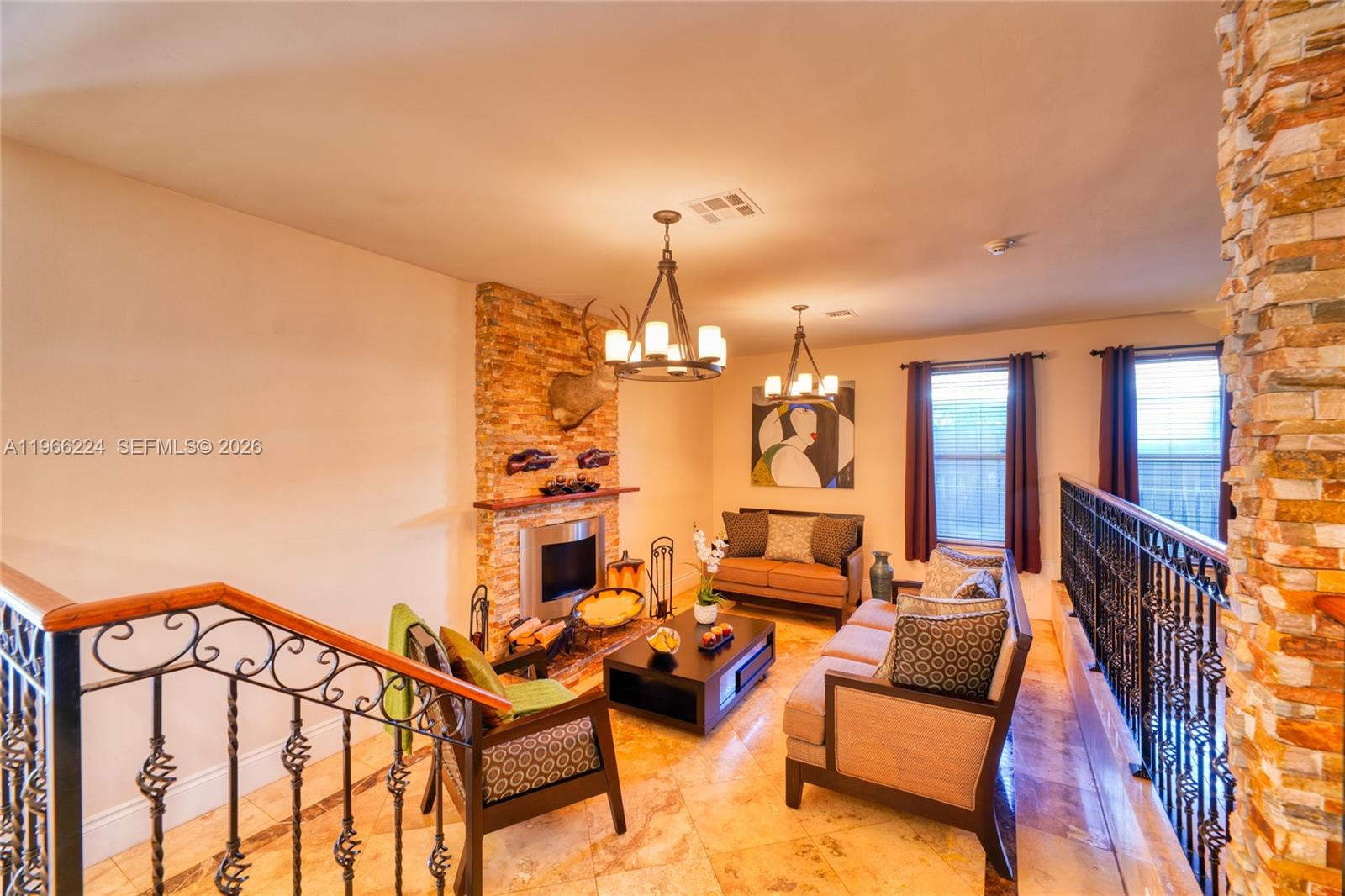 5826 Southwest 17th Street Miami, FL 33155 - Photo 11 of 46 a living room with patio furniture and a chandelier