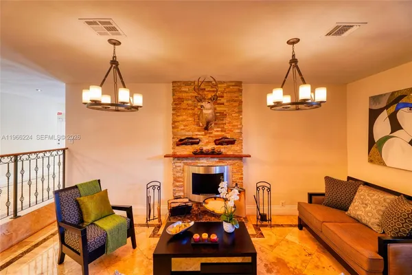 a dining room with furniture a chandelier and wooden floor