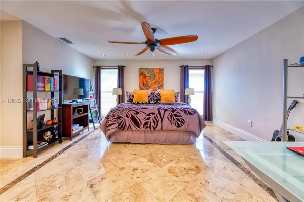 a bedroom with a large bed and a large window