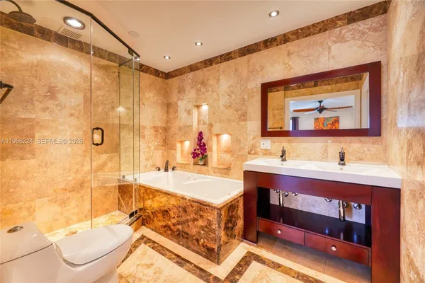 a bathroom with a double vanity sink mirror and bathtub
