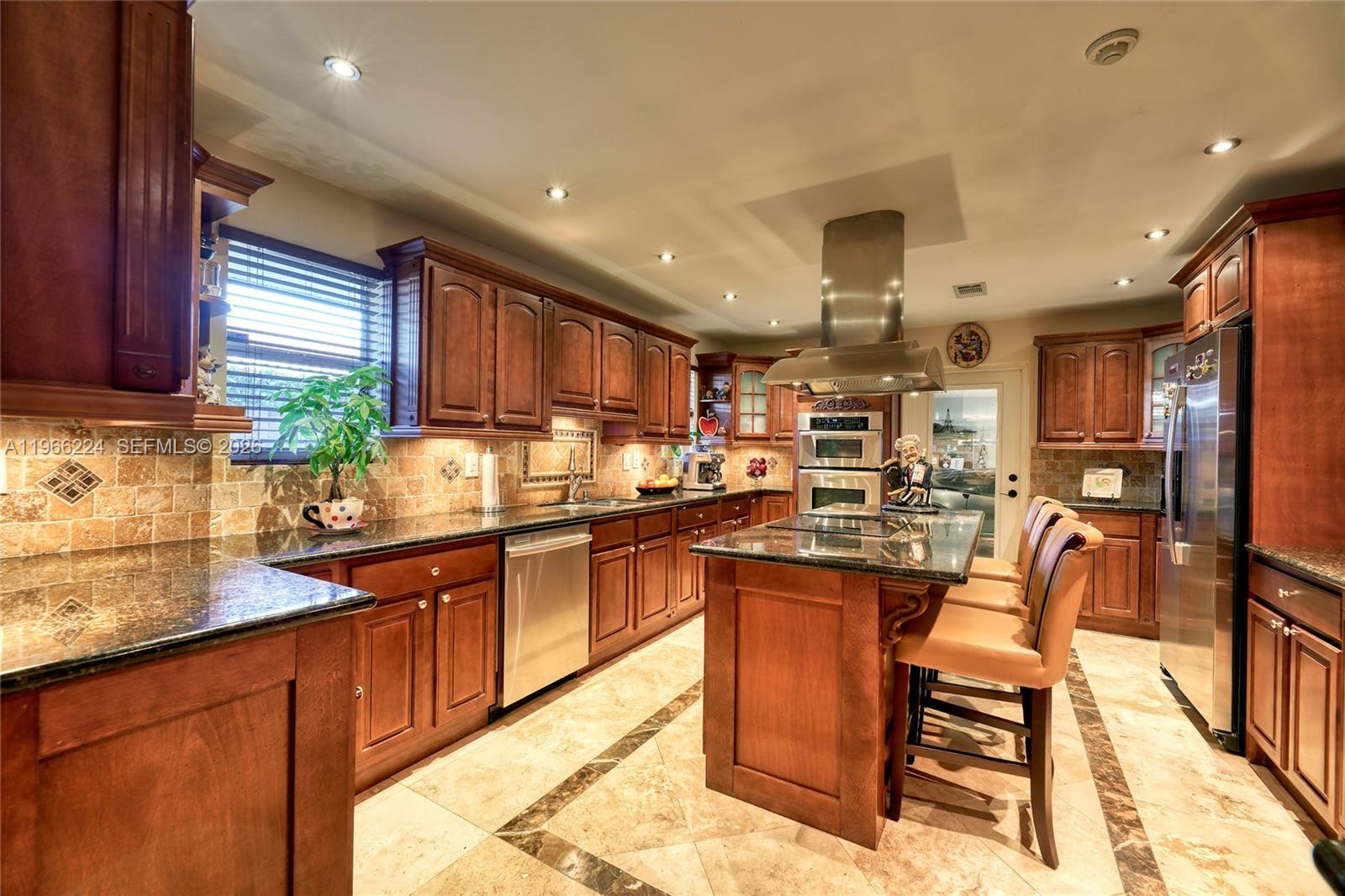5826 Southwest 17th Street Miami, FL 33155 - Photo 2 of 46 a kitchen with lots of counter top space and appliances