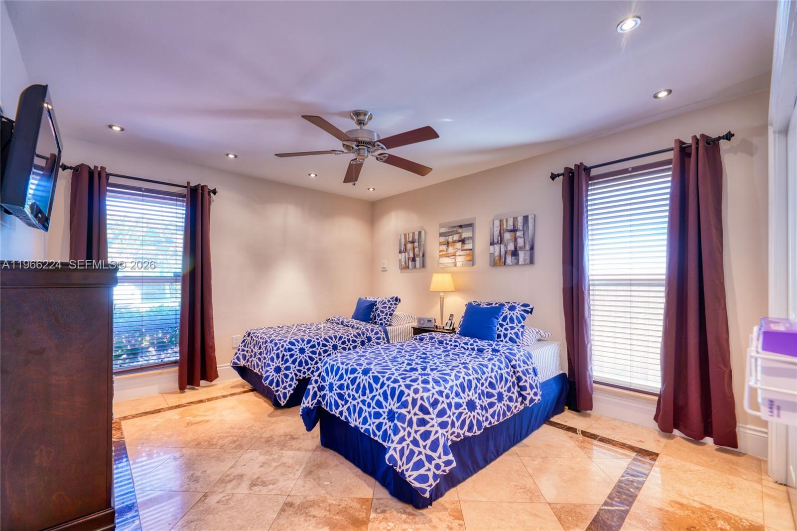 5826 Southwest 17th Street Miami, FL 33155 - Photo 23 of 46 a bedroom with a large bed and a chandelier