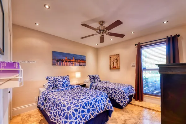 a bedroom with bed and window