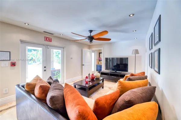 a living room with furniture kitchen and a window