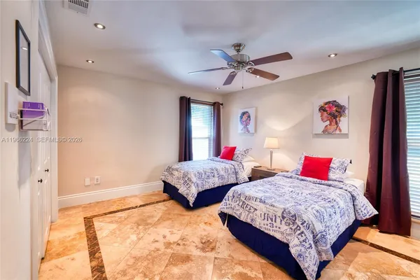 a bedroom with two beds and a chandelier