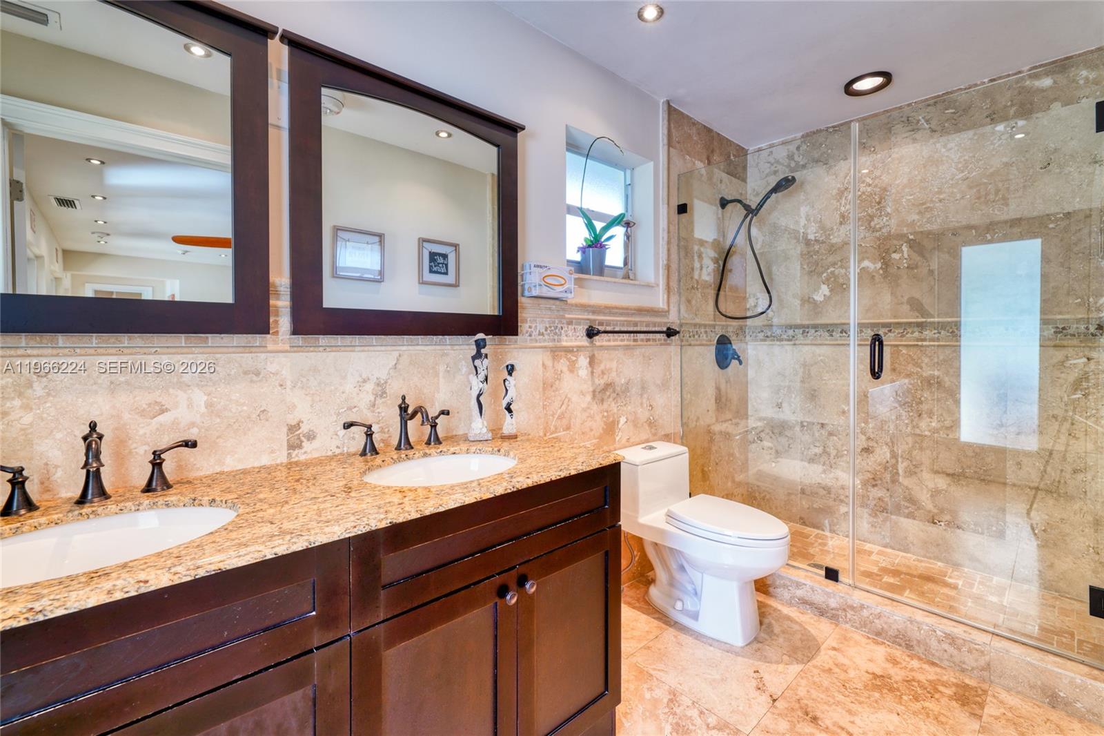 5826 Southwest 17th Street Miami, FL 33155 - Photo 33 of 46 a bathroom with a granite countertop sink toilet and shower