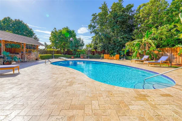 a swimming pool with outdoor seating and yard