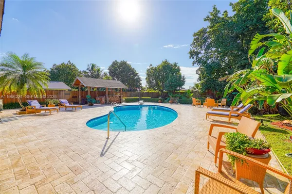 an outdoor space with swimming pool and furniture