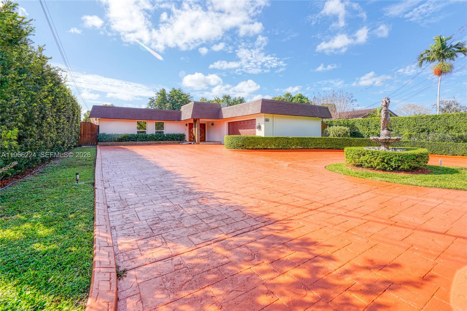 5826 Southwest 17th Street Miami, FL 33155 - Photo 44 of 46 a front view of a house with a yard and trees