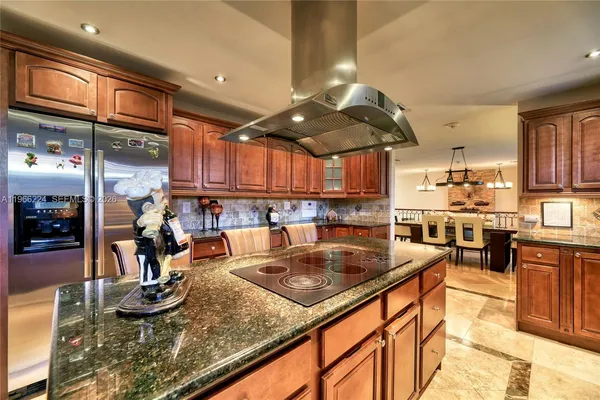 a kitchen with stainless steel appliances granite countertop a sink counter space and cabinets