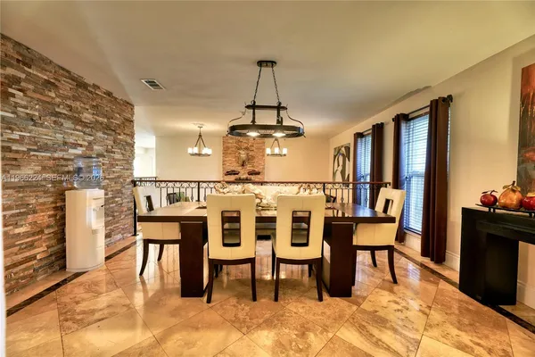 a dining room with furniture a rug and a chandelier