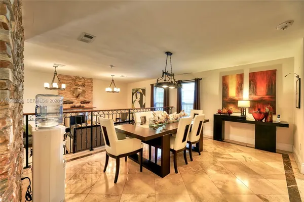 a dining area with a table chairs and a kitchen view