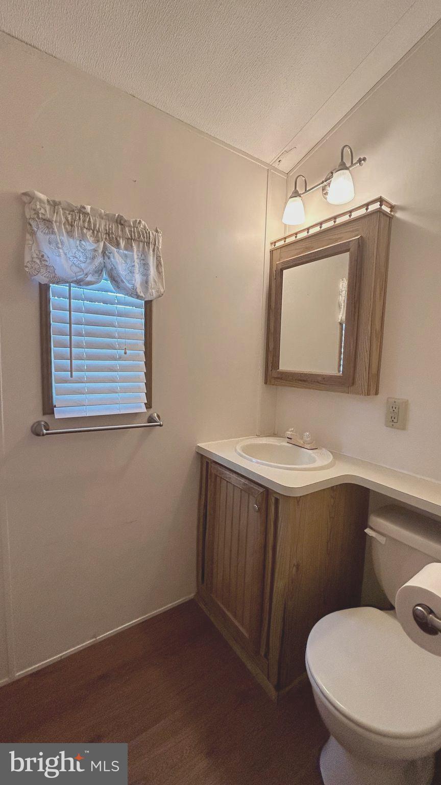 104 South 5th Avenue, Unit 39 Rio Grande, NJ 08242 - Photo 11 of 20 a bathroom with a toilet sink and mirror